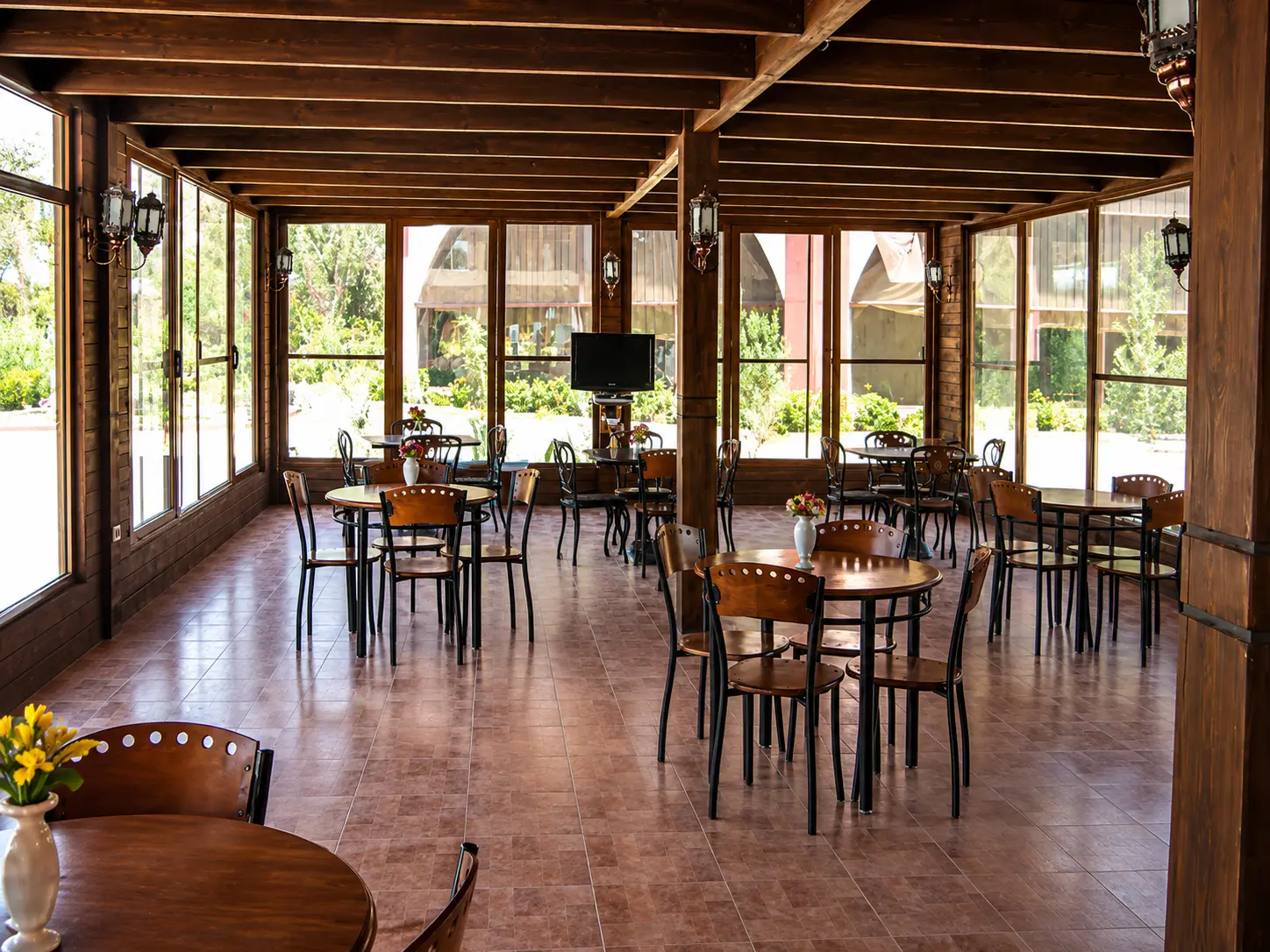 Wooden coffee shop with garden views and traditional lanterns