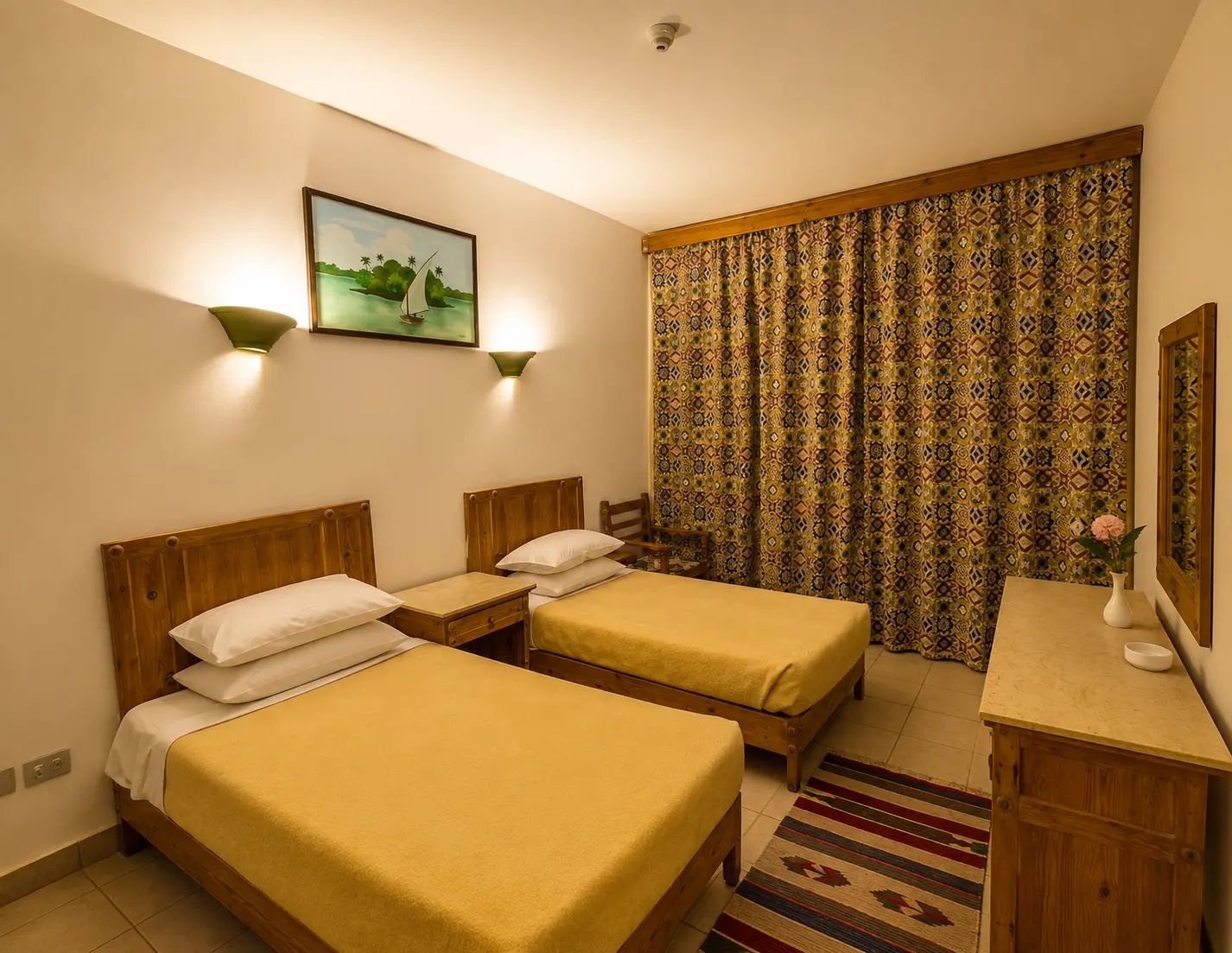 Twin room with wooden furniture and traditional Bedouin textiles