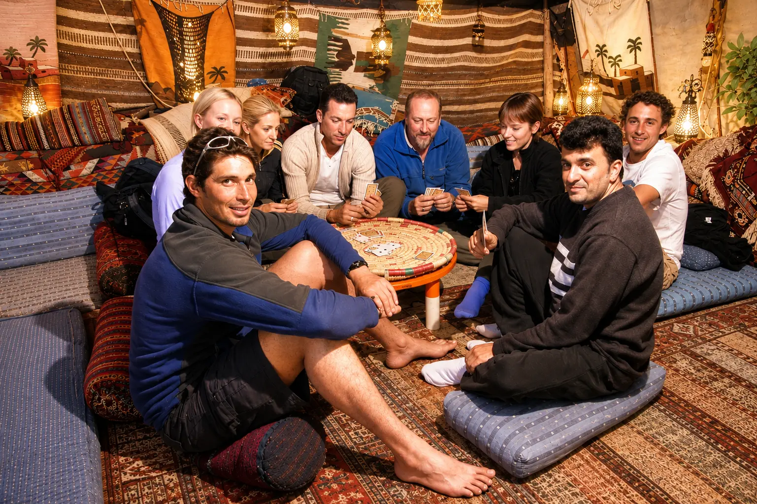 Guests relaxing and playing cards in the Bedouin tent lounge