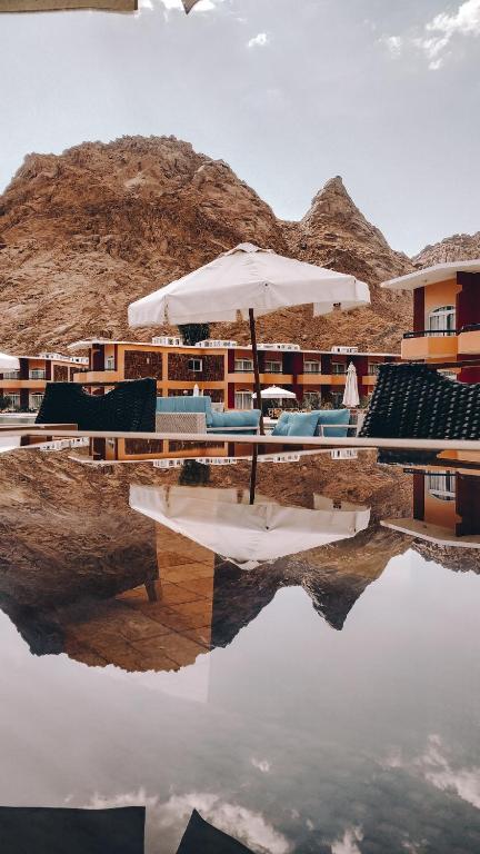Reflection of village buildings and mountains in a clear glass surface